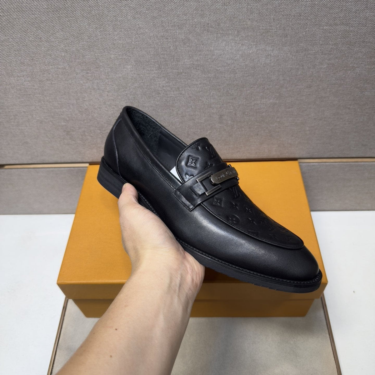 Louis Vuitton Embossed Metal-Bar Loafers — model